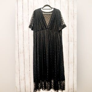 Flowy black dress with star pattern.